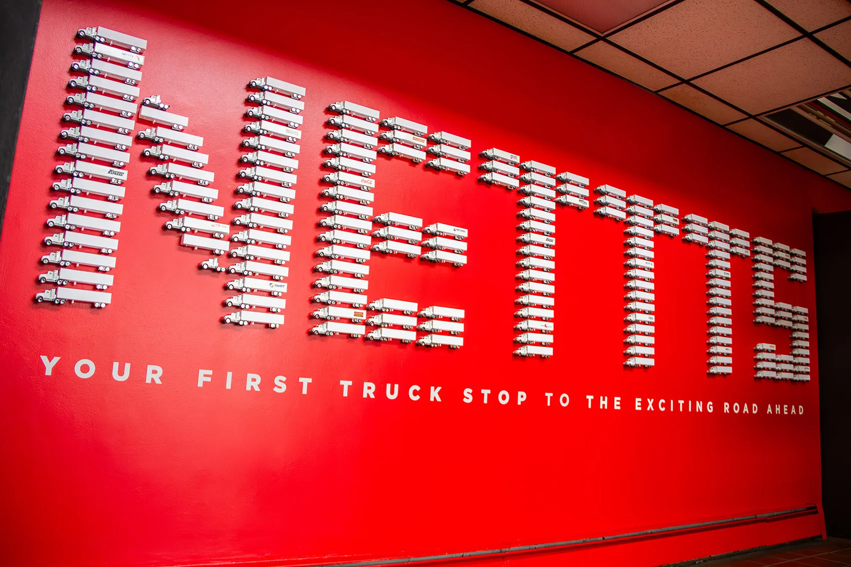 wall art with small trucks spelling out NETTTS